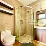 A bathroom with a glass shower and sink