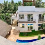 A house with a pool and palm trees