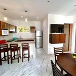 A kitchen and dining area with a table and chairs