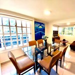 A room with a glass table and chairs
