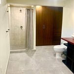 A bathroom with a shower and toilet